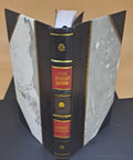 Front view: Leather-bound book on regenerative braking; black spine with red title panels and gold bands.