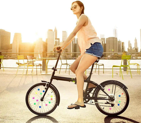 216 Piece Assorted Colors Bike Spoke Beads Clips Set For Wheel Decorations on bicycle wheels in urban setting with cyclist