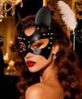 Premium Black Leather Rivet Cat Masquerade Mask Featuring Adjustable Back Buckle worn by woman with curls and bold makeup.