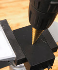 Close-up of a drill using Six Piece High Speed Reaming Pagoda Sawtooth Drill Bit Set With Titanium Plating In Box For Metal
