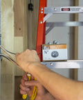 Electrician installing 3/8 To 1/2 Inch Knockout Non-Metallic Push-In Connector Gray 100 Pack Model 75105B in electrical box
