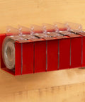 Modular Sandpaper Dispenser For Dedicated Woodworkers Includes Six Aluminum Oxide Rolls wall-mounted with transparent holders.