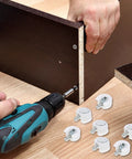 White Furniture Shelf Support Pegs Cam Lock Fasteners With Cabinet Connectors For Hidden Shelf Brackets And Wardrobe Panel Assembly 30 Piece Set being installed with a drill.