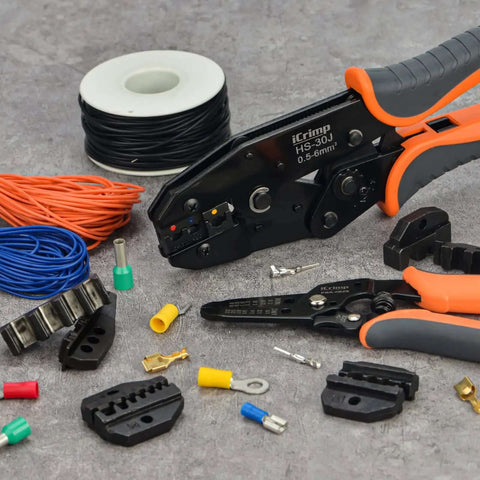 Pro Grade Ratchet Wire Crimping Tool Set With 5 Interchangeable Jaws, wire stripper, AWG 20 to 2 terminals on a workbench.