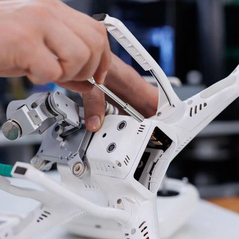 Using Five Point Five Millimeter Nut Driver Drill Bit Set with Six Point Sockets on drone assembly for precision fastening.