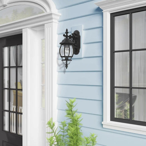 Frontenac 1 Light Outdoor Wall Lantern with clear beveled glass shades, black finish mounted on blue house exterior
