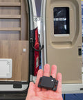 Rugged RV Cabinet Latches With Drawer Grabber Locks For Camper And Travel Trailer In Motion, black ABS latch in hand beside RV door