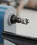 Close-up of a Four Prong Spring Loaded Spur Drive Center 2MT on a wood lathe with strong 1 inch grip and sharp spurs.