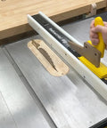 SavR Push Block For Table Saw And Router Table, With Magnetic Fence Mount guiding wood past blade on table saw