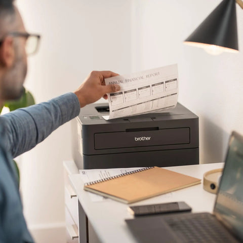 Compact Wireless Monochrome Laser Printer With Mobile Printing And Alexa Compatibility For WFH Home Offices Black And White Output Up To 30 Pages Per Minute Includes Refresh Subscription Trial on desk