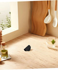 Rubber Steam Pipe Sleeve Insulation Kit for Coffee Maker wand on a wooden kitchen countertop near a cutting board and utensils.