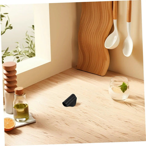 Rubber Steam Pipe Sleeve Insulation Kit for Coffee Maker wand on a wooden kitchen countertop near a cutting board and utensils.