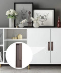 Zinc Alloy Flush Pull Handles Set Of 2 For Sliding Doors And Drawers in brown, installed on a modern white cabinet with decorative items on top.