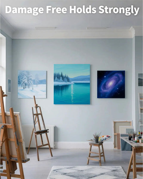 Heavy Duty Drywall Canvas Hangers And Claw Hooks Damage Free Picture Hanging Kit displayed in a bright studio with paintings.
