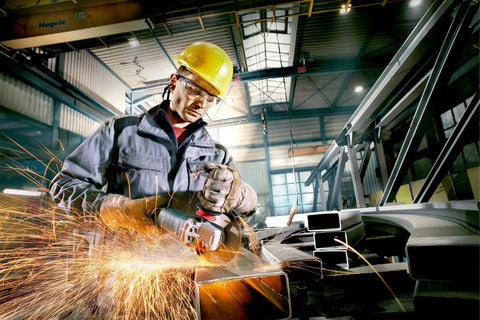 Worker using Beefy Four And A Half To Five Inch Angle Grinder With Eleven Thousand RPM And Twelve Amp Power AC DC Versatility.