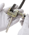 KAMIER roller chain breaker tool, zinc-plated steel, with threaded bolt, shown in close-up with a chain.