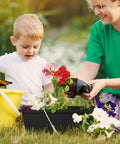 Child planting flowers in Heavy Duty Black Balcony Rail Planters 16.9 Inch Deck Flower Boxes with a parent.