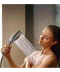 Woman using Raindance Select S Adjustable 5 Inch Handheld Shower Head Set with PowderRain spray in bathroom