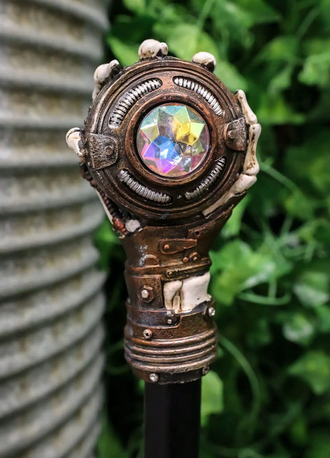 Badass Steampunk Swagger Cane Featuring Skeletal Hand Grasping Evil Eye And Heavy Duty Clockwork Gear Decor Staff For Victorian Costume Fans And Top Tier Home Display Vibes, close-up of skeletal hand and colorful gem.