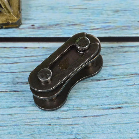 Heavy Hitter Stainless Steel Chain Master Links For Bikes And Cycles No Sweat Connector Repair Parts close-up view on wooden background.