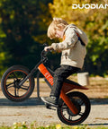 Kids Electric Bike With 350W Motor 36V 7.8Ah Battery Zippy Up To 15.5 MPH, 15 Mile Range, 16 Inch Pneumatic Tires, Off Road Balance Bike For Ages 6 And Up, Youth All Terrain Electric Bicycle, child riding orange frame side view
