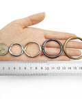 15 Pack Round Carabiner Clips With Trigger Spring O Rings Gold Finish One Inch And One Half Inch Sizes Metal Keychain Rings on hand with ruler
