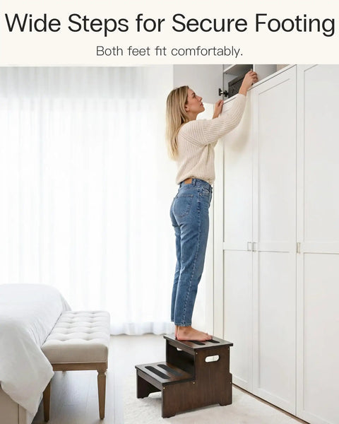 Woman using Rock Solid Bamboo Two Step Stool For Adults And Seniors 400 Pound Heavy Duty Workhorse to reach overhead cabinet.