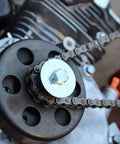 Close-up of Beefed Up Kart Sprocket Kit Three Quarter Inch Bore Twelve Tooth Heavy Duty Steel with Tool for Thirty Five Chain fitting engine.