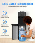 Person placing water bottle in self cleaning bottom loading water cooler dispenser in black stainless steel with three temperature settings hot room and cold water easy bottle refill and no fuss back saving convenience for home or office