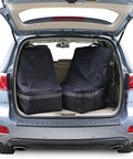 Open car trunk with two black Padded Car Seat Travel Bag For Airplane Travel With Shoulder Strap Heavy Duty Carrier Fits Most Major Brands