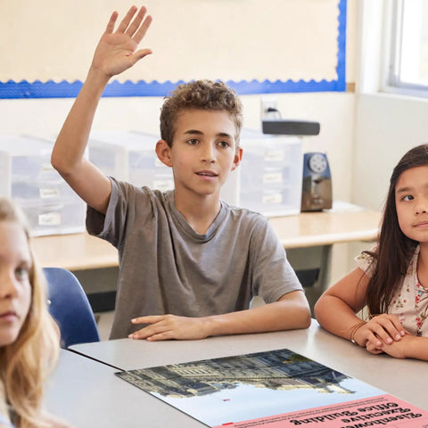 Student raising hand in class with US Government Buildings poster, part of Eight Poster US Government Buildings Set For Classrooms.