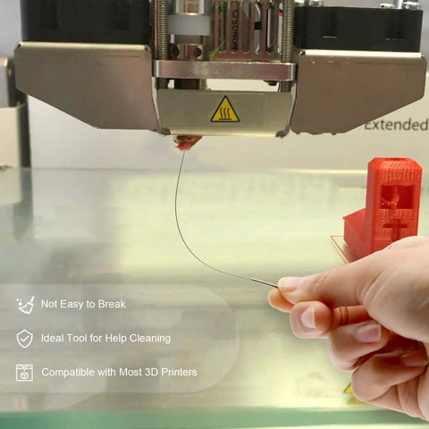 Hand using needle from 3D Printer Nozzle Cleaning Kit 13 Piece Set With 0.4mm Cleaning Needles to clear blockage on 3D printer nozzle