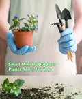 Person holding Six Piece Iron Garden Tool Set With Hand Shovels Transplant Shovel And Hand Rake, Wood Non Slip Handles
