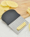 Crinkle cutter with black handle and multiple stainless steel blades for crinkle-cut fries.