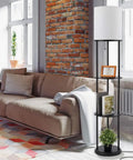 Versailles Floor Lamp With Built-In Shelves, 57.5 Inch Matte Black, White Linen Shade beside sofa in living room.