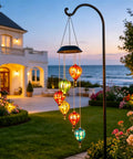 Solar Wind Chimes Outdoor Lights With 30 Warm White LEDs Hot Air Balloon Style Hanging Decor in garden at sunset.