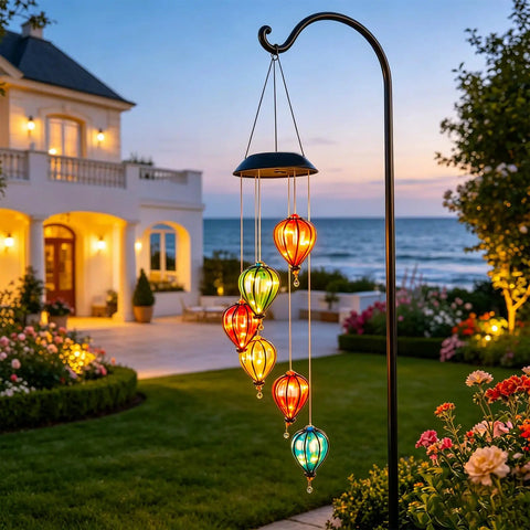 Solar Wind Chimes Outdoor Lights With 30 Warm White LEDs Hot Air Balloon Style Hanging Decor in garden at sunset.