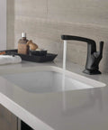 Sleek Matte Black Vesna Bathroom Faucet with drain kit, single or three-hole four-inch configuration, shown on vanity.