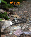 Sofirn SP10 Pro BLF Anduril2 Version Mini EDC Flashlight on wet ground, demonstrating IPX8 waterproof capability in rain
