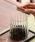 Level Up Your Kitchen With This Tough Clear Glass Storage Jar Boasting A Tight Airtight Wooden Lid Sealed Cap For Grains Coffee Beans Candy And Spices To Keep Everything Fresh On Hand, showing tea being stored.