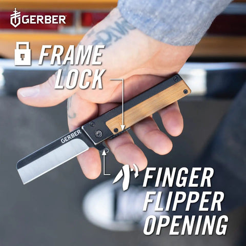 Hand holding Quadrant Clip Folding Knife with bamboo handle, showing frame lock and flipper opening mechanism.