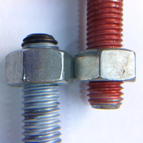 Close-up of two metal bolts, one wrapped with Copper Anti Seize Tape For Threads Three Quarters Inch By Fifty Feet PTFE Resin With Metal Flakes