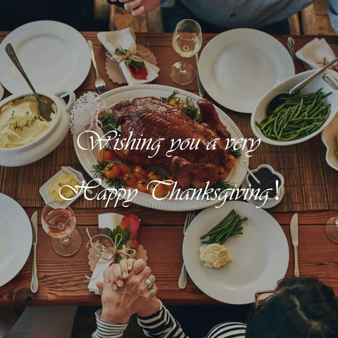 Thanksgiving dinner table with turkey, mashed potatoes, green beans, and people holding hands, featuring 'Wishing you a very Happy Thanksgiving' text