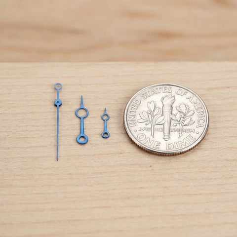 Metal Watch Hands Set for NH35 364R and 7S Movements, against a dime, showcasing size and pro-grade blue finish.