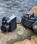 430 GPH Pond Pump 120V Submersible Fountain Pump With Auto Low Water Shut Off 31W shown with coiled 16 ft cord outdoors.