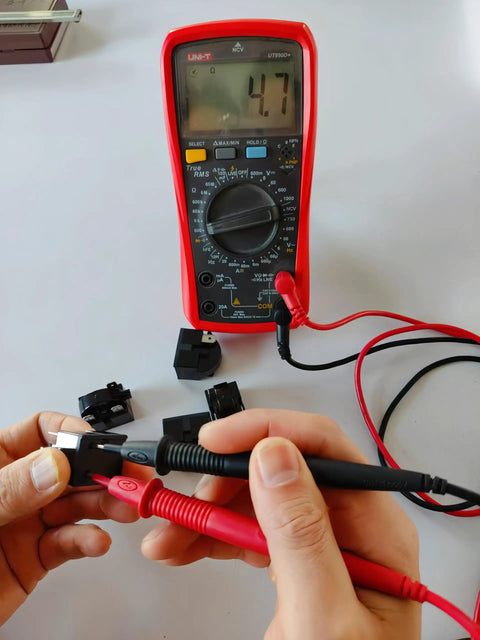 Hands testing 3 Pin 4.7 Ohm Refrigerator Start Relay Kit with multimeter, 4.7 reading visible on screen, durable electric start.