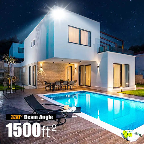 Outdoor 150W LED Flood Light With Dusk To Dawn Photocell illuminating a modern house pool area at night, wide beam.