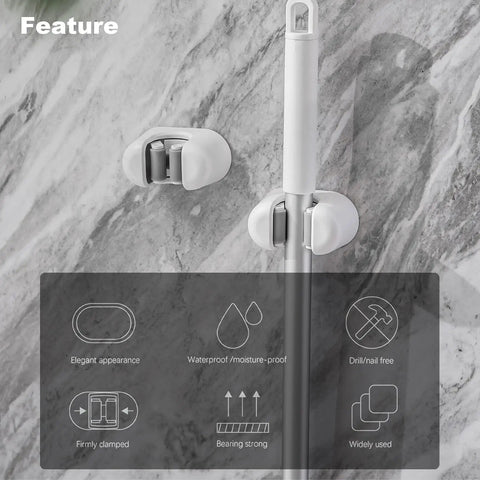 Three Pack Wall Mount Mop And Broom Holder Organizer With Self Adhesive Clips For Bathroom Kitchen Garage Garden Made Of ABS Plastic Sturdy Non Slip Hanger Rack mounted on a marble wall with icons showcasing features.