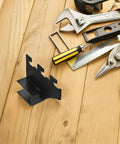 Black Stainless Steel Shelf Brackets 2 Pack With Square Pipe Design next to tools on wooden surface.