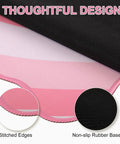 Close-up of pink heart XXL mouse pad with scalloped edge, showing non-slip rubber base, and stitched edges.